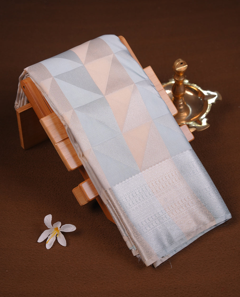 Ice blue & cream colour semi soft silk saree featuring a silver zari patterned body, complemented by silver zari motifes on pallu & border and a matching blouse piece.