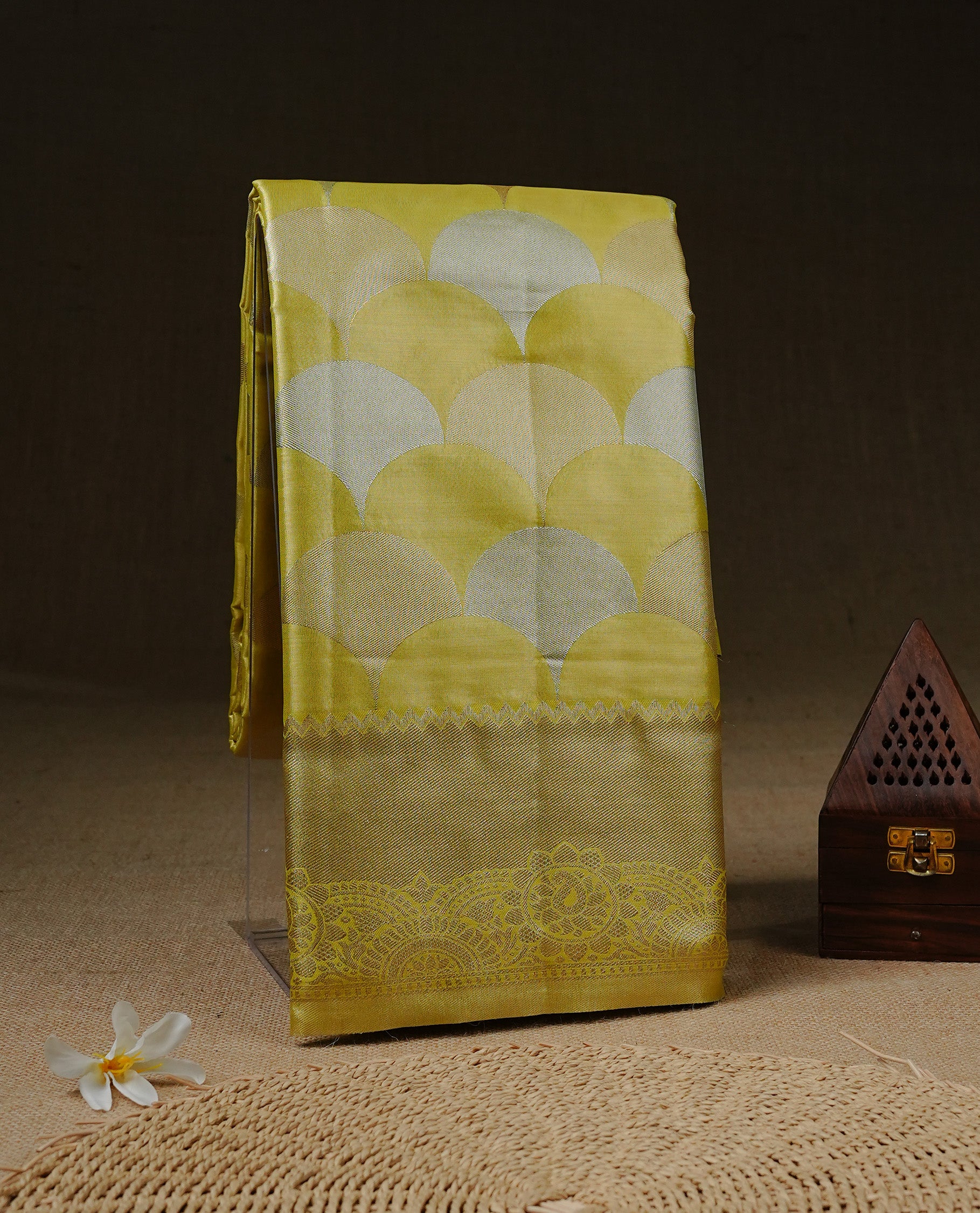 Yellow colour Tissue saree Featuring yellow, Gold, silver zari Scales design on body, complemented by traditional border on self colour, paired with matching blouse piece.