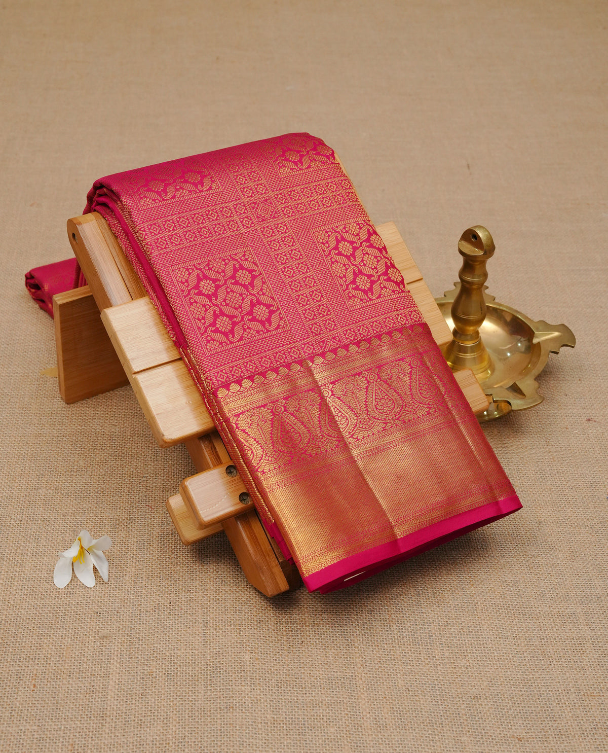 Magenta colour pure wedding silk saree featuring gold zari box Designed pattern on body, comeplemented by self colour with traditional border, comes with matching blouse piece.