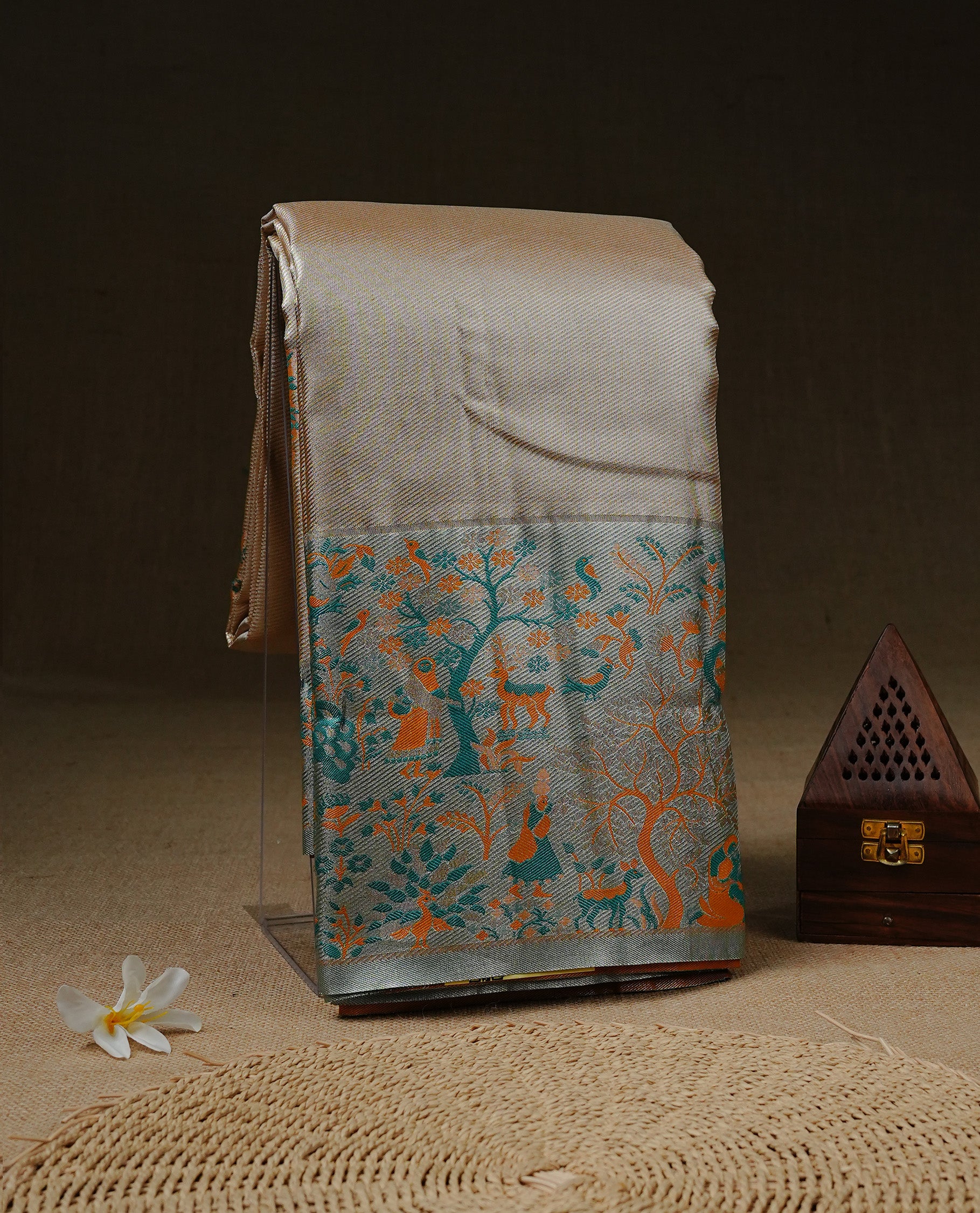 Golden colour Tissue Silk Saree features intricate tree Motifs on body and fancy border & pallu with floral patterns, paired with matching blouse