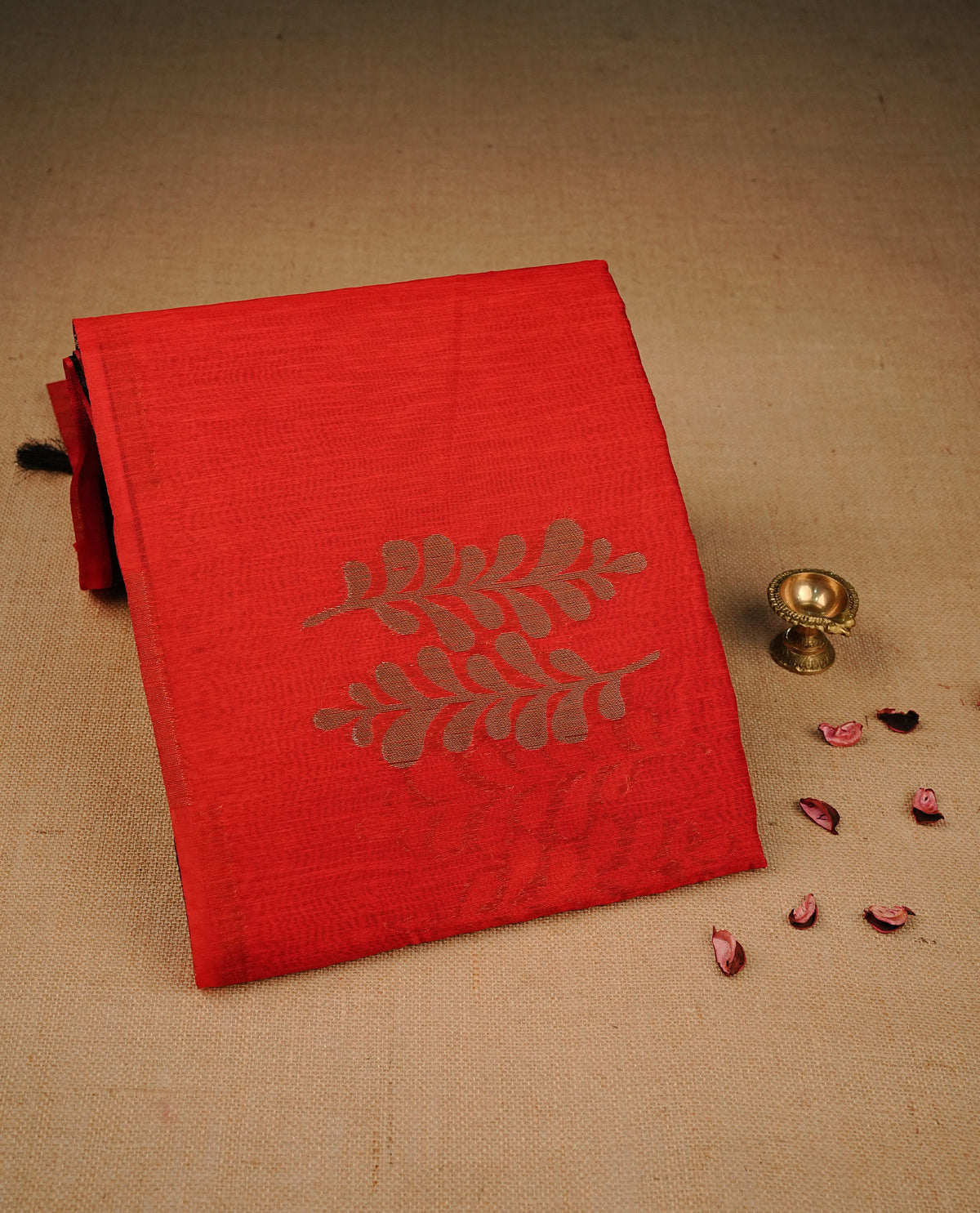 Red colour semi linen saree with elegant gold zari leaf motifs across the body, complemented by a contrast Black colour with grand gold zari pallu and a borderless design, paired with a matching blouse piece.