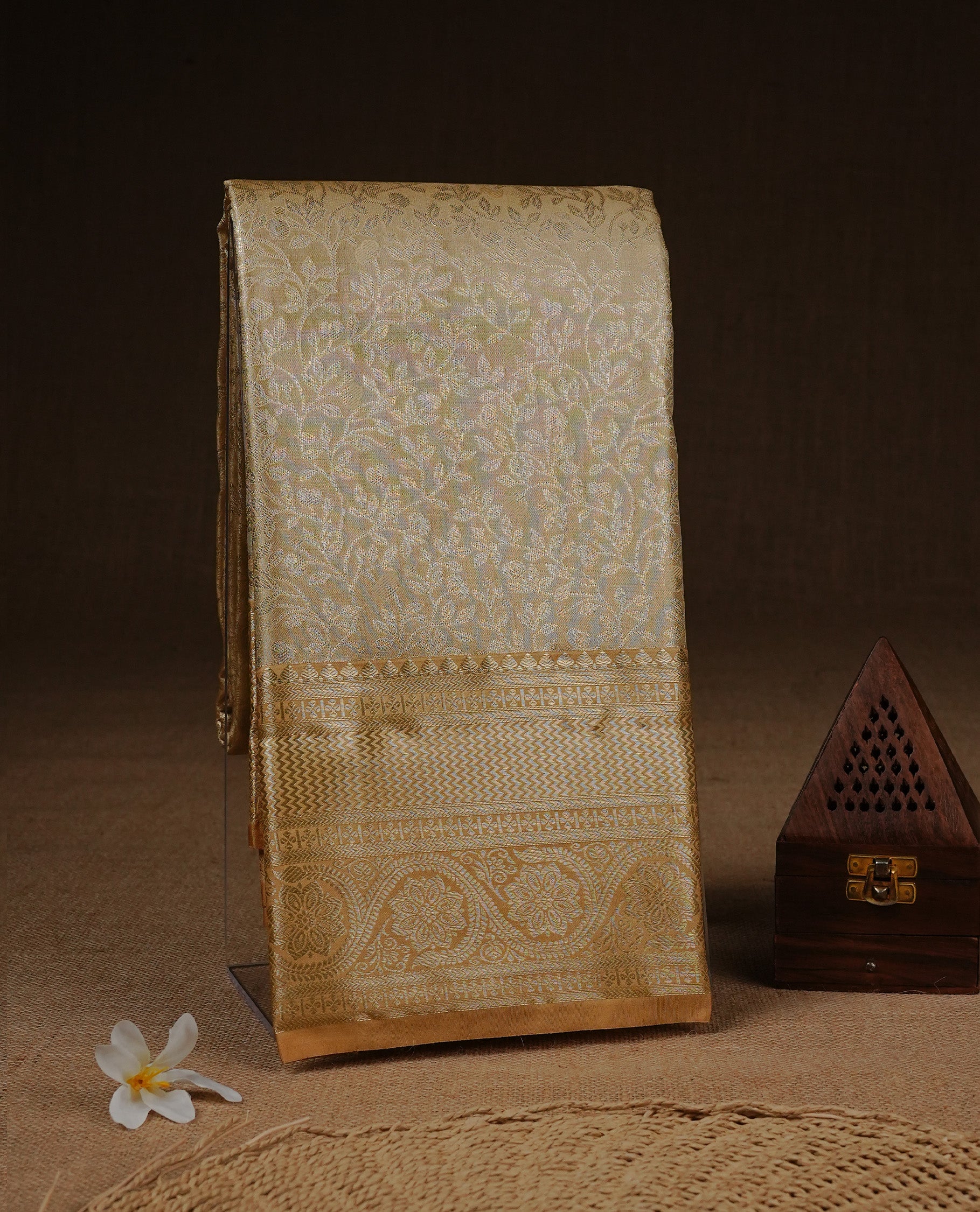 Golden Cream colour Semi Tissue silk saree featuring Gold zari kodi pattern on body, complemented by traditional border with self colour, paired with matching blouse piece.