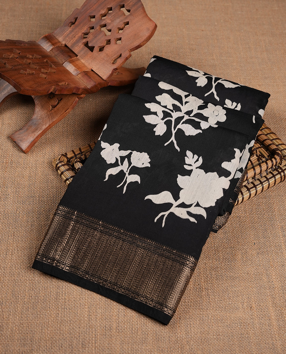 Black colour Viscos semi printed saree featuring a light golden zari border, abstract off white printed motifs on the body, and comes with a matching blouse