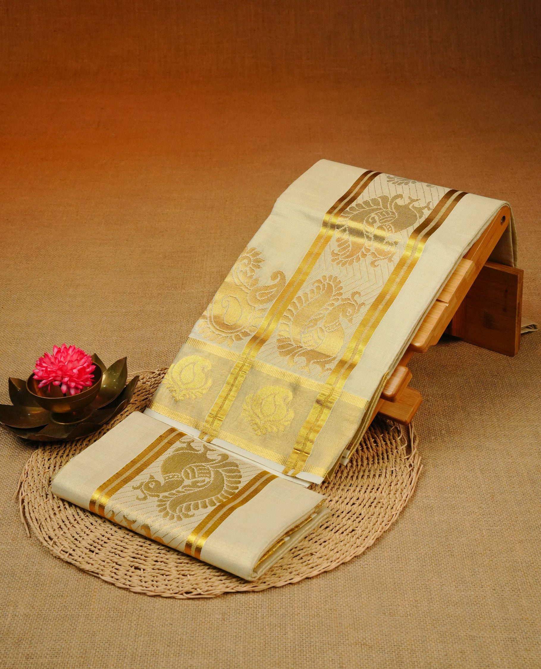 Cream Colour tissue set mundu featuring a plain body, enhanced with elegant Peacock Design on the gold zari kara.