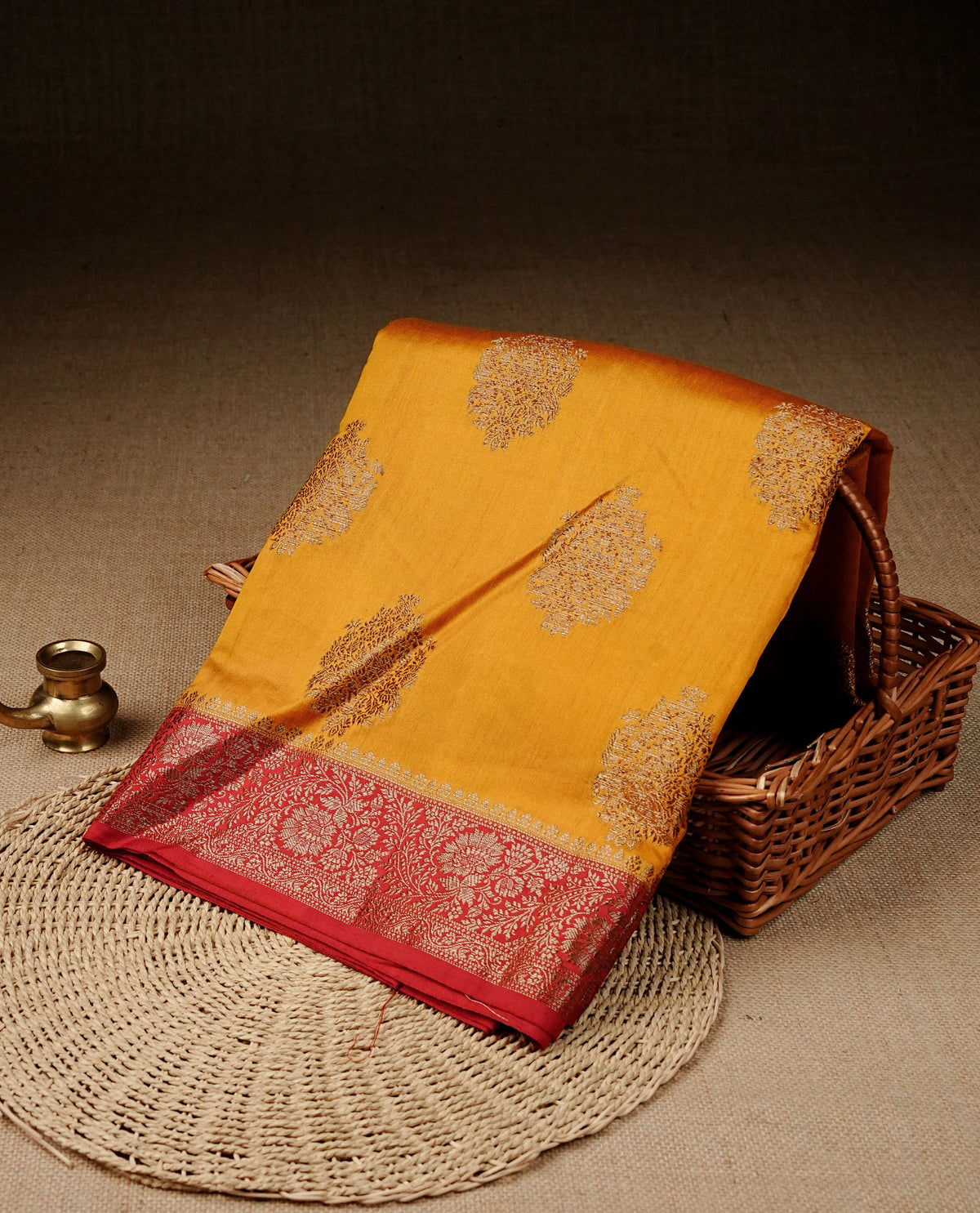 Mustard colour banaras saree featuring gold zari motifs on body, complemented by contrast Maroon colour with gold zari border, comes with matching blouse piece.
