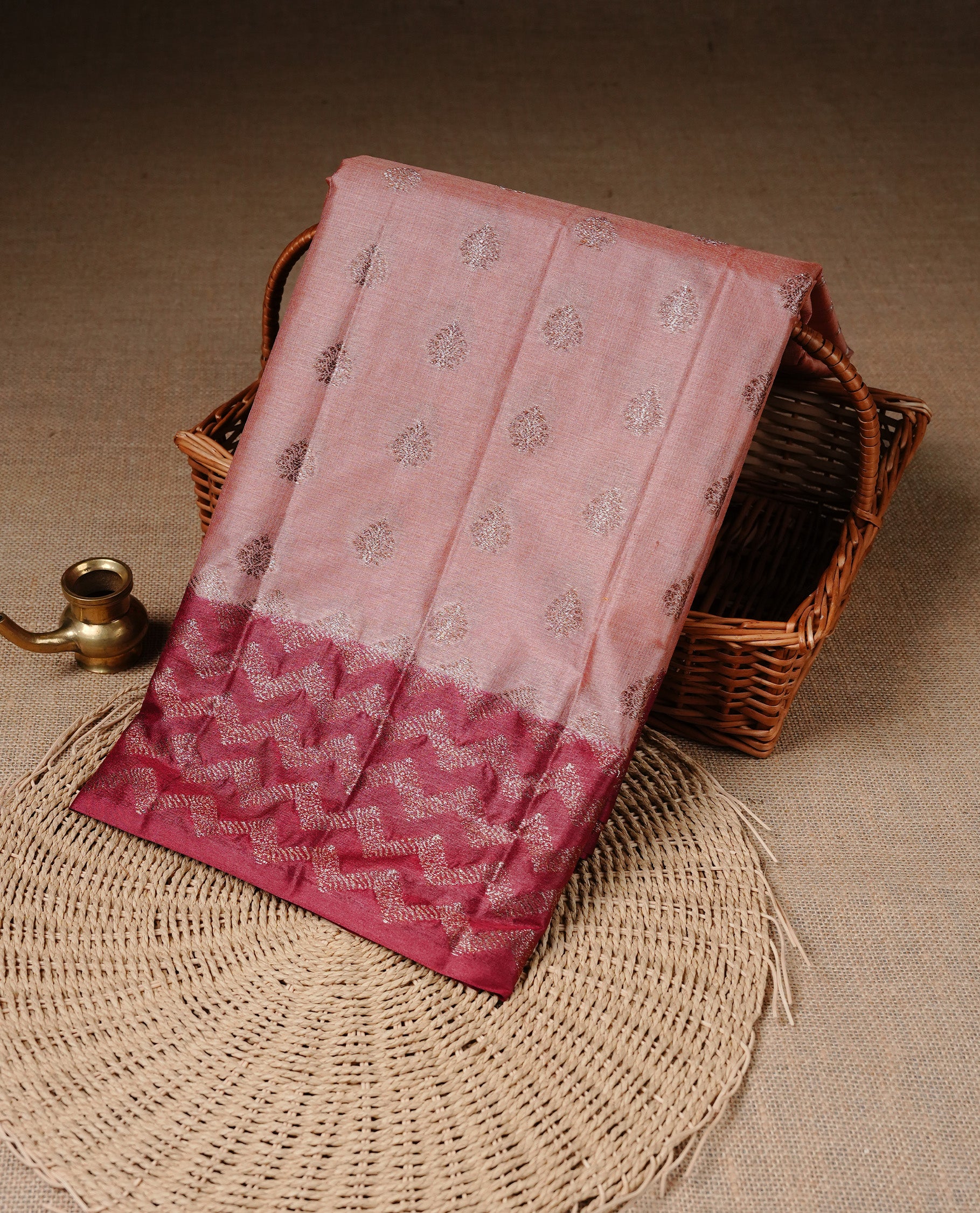 Peach Colour Tussar silk saree featuring Antique Zari motifs on body, Finished with contrast Maroon colour Zigzag zari pattern border, paired with matching blouse piece.