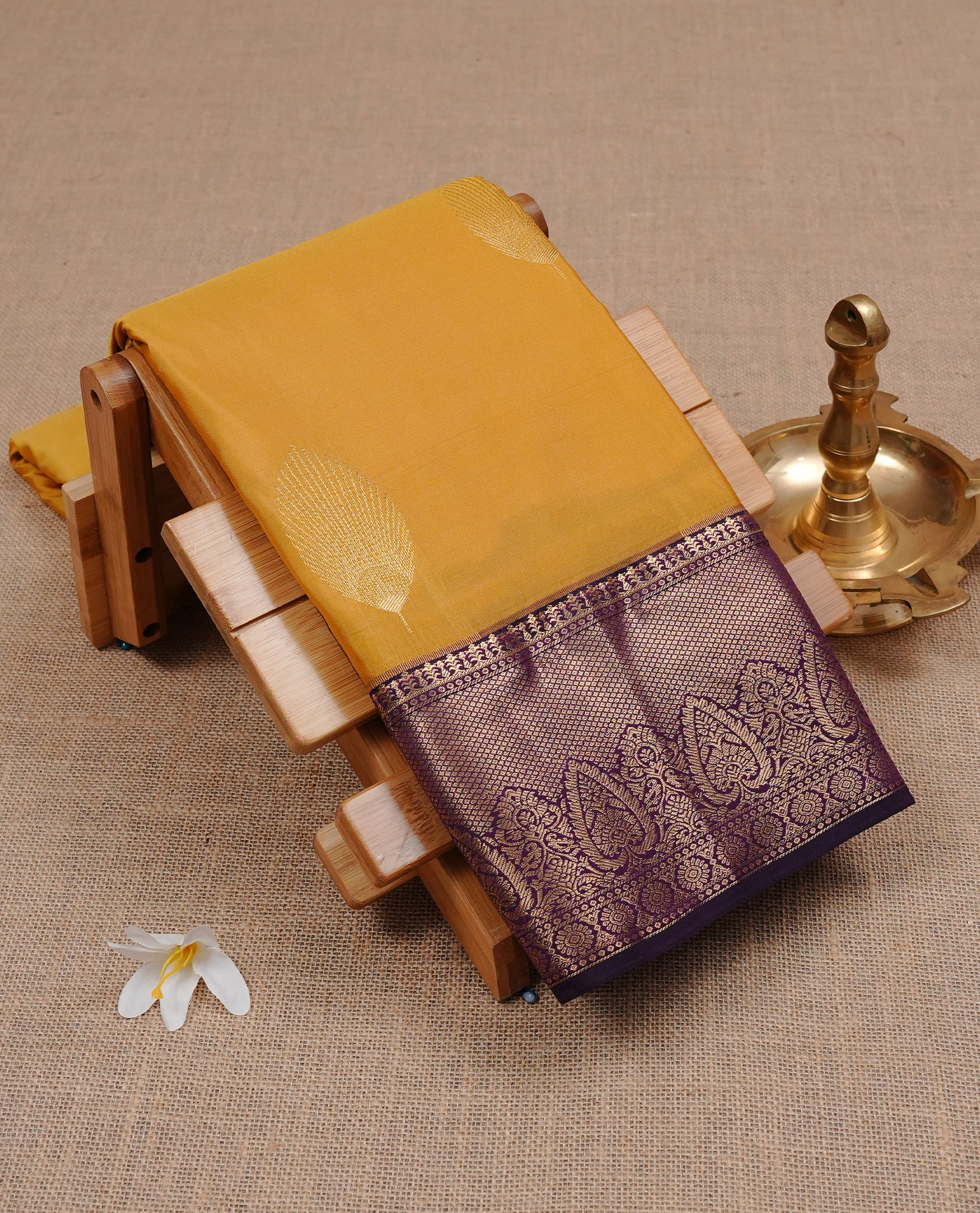 Yellow colour semi Wedding silk saree featuring Gold zari motifs on body, enhanced with Contrast Purple colour with traditional border, paired with matching blouse piece.