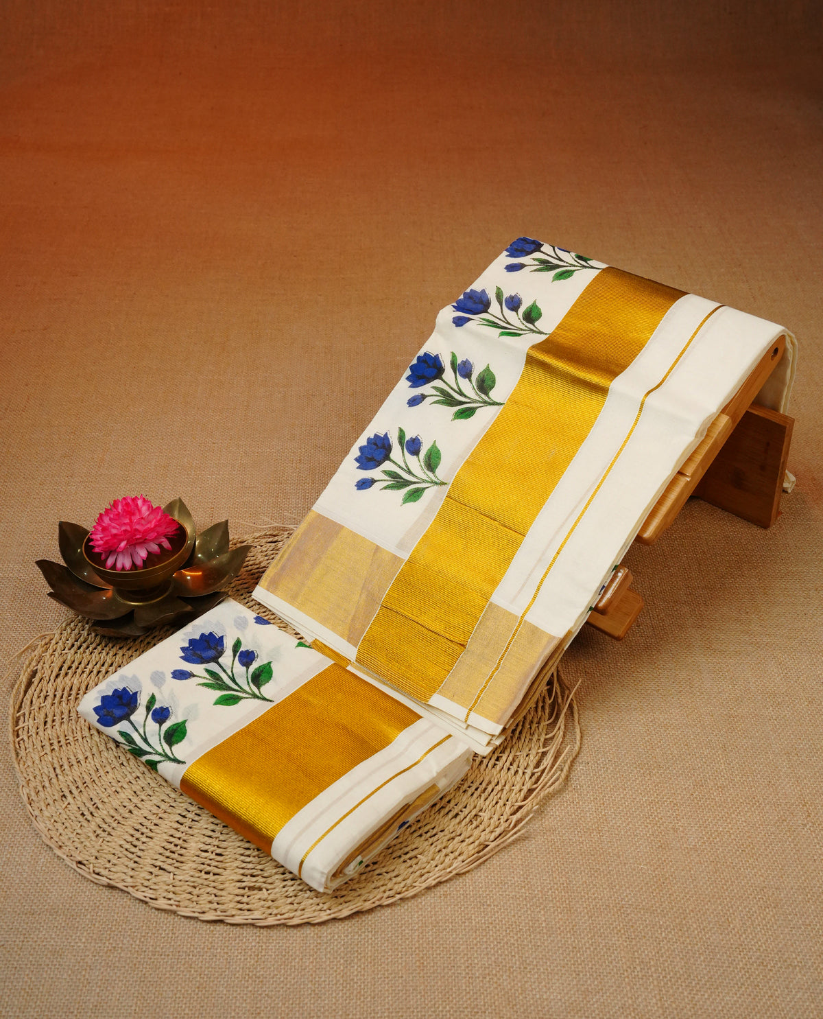 Cream colour cotton set mundu featuring kasav kara with Blue flower print.