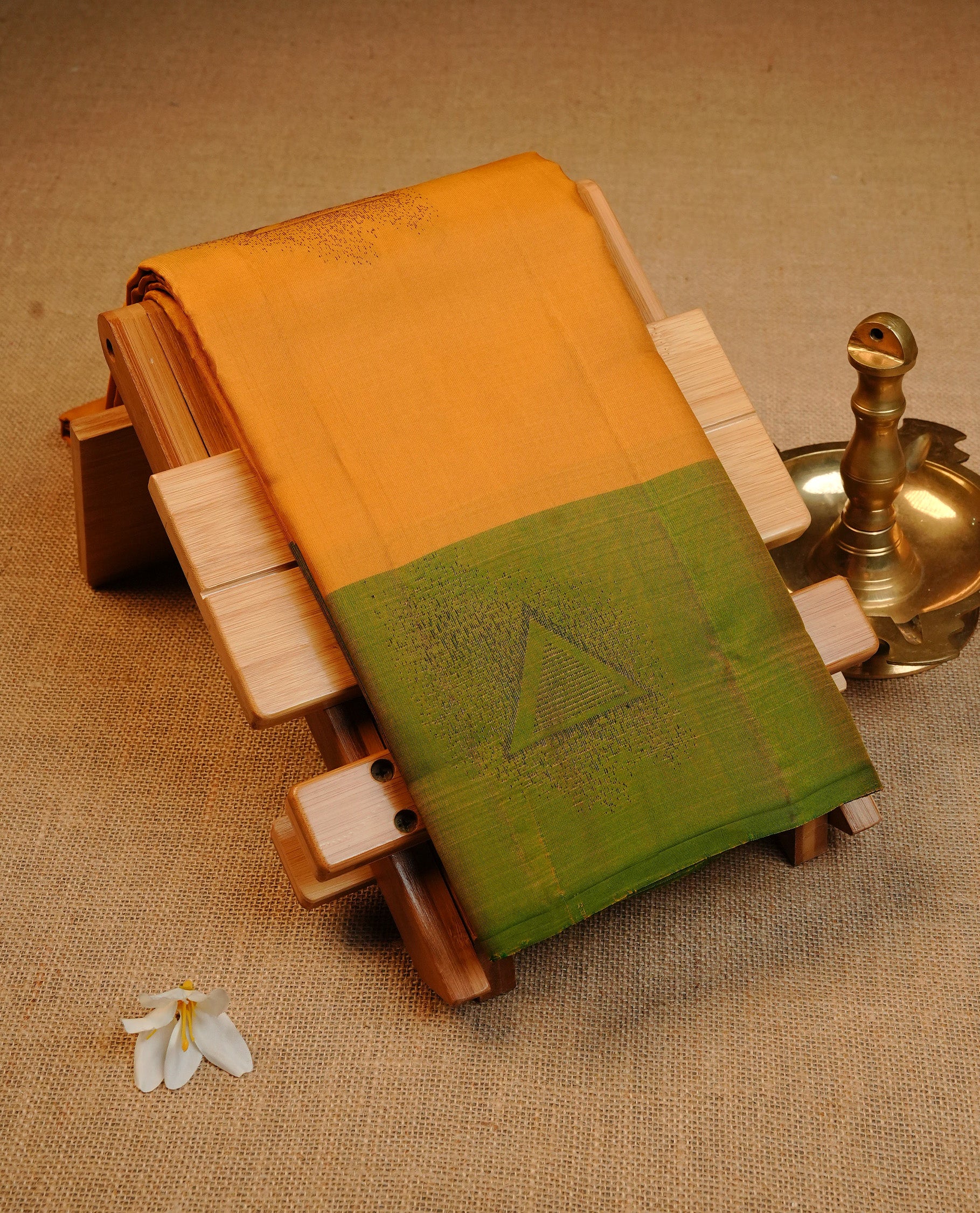 Mustard Colour Traditional Kancheepuram Silk Saree Featuring Bronze Zari Triangle Motifs on the Body, Designed With a Green Border and with a Grand Pallu, Paired with a Matching Blouse.
