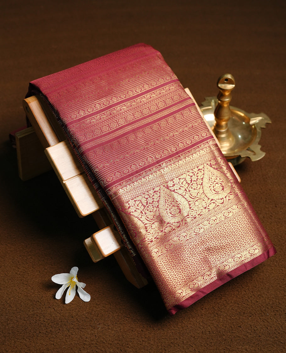 Chocolate colour semi wedding saree featuring gold zari pattern stripes on body, self colour with traditional border, paired with matching blouse piece.
