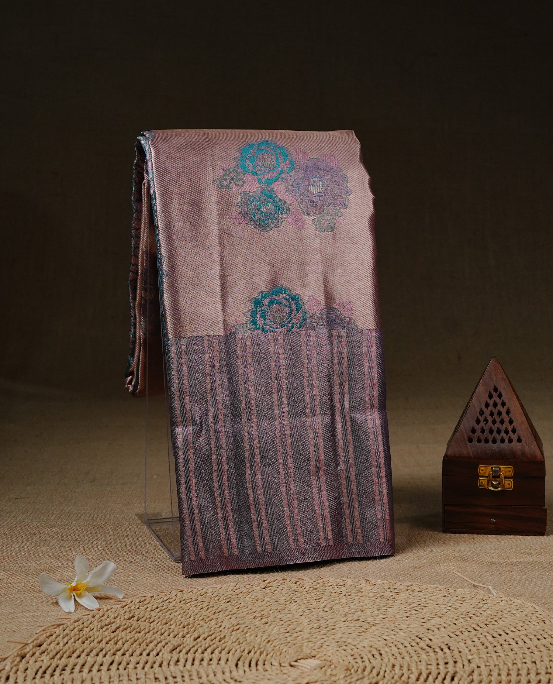 Rose Gold colour Tissue silk saree featuring Green colour floral zari motifs on body, complemented by contrast Light purple zari border, paired with matching blouse piece.