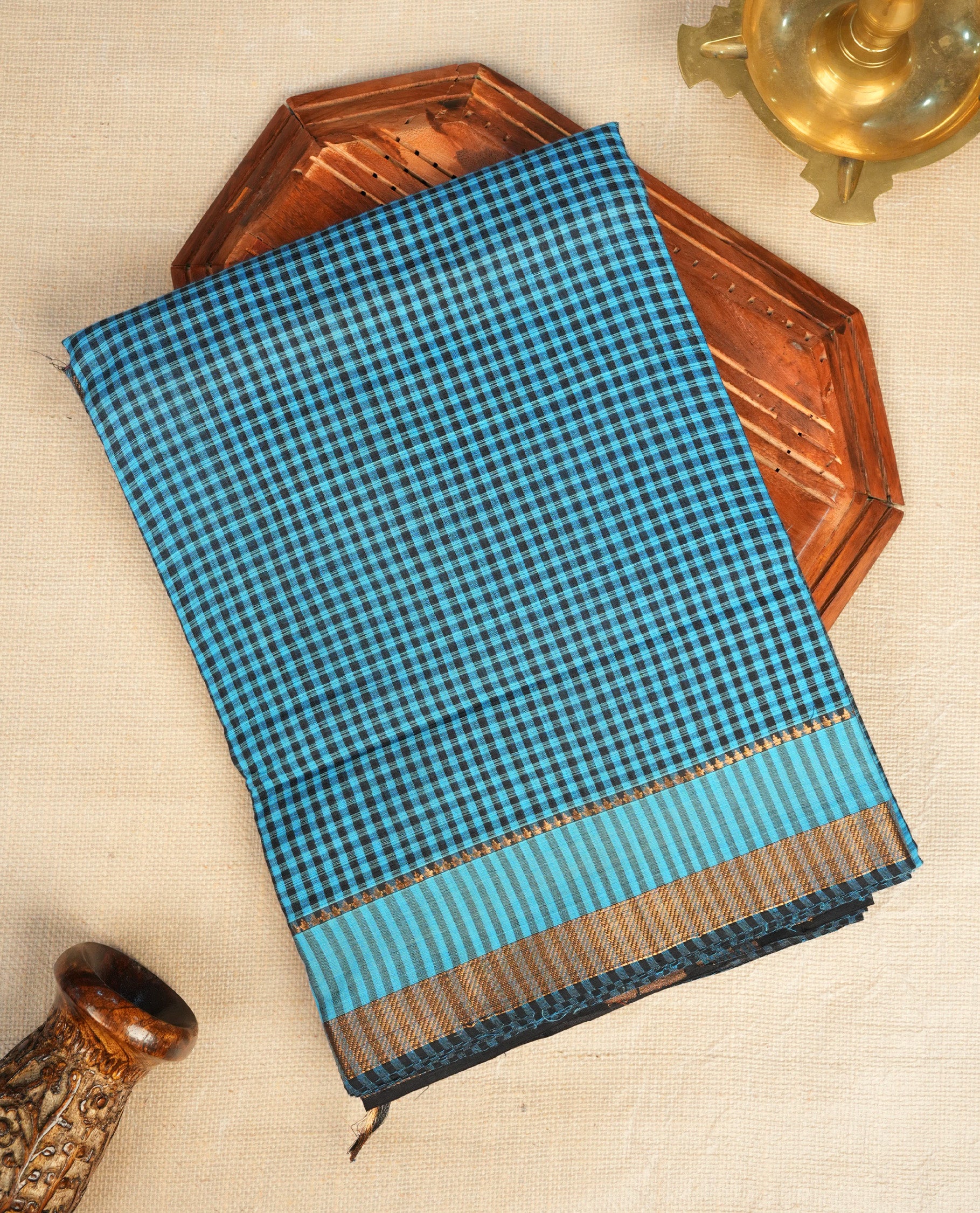 Black Colour Mangalagiri cotton saree featuring elegant blue Checks Across The Body ,A Gold zari border & Gold Zari Pallu, Paired With a matching blouse piece.