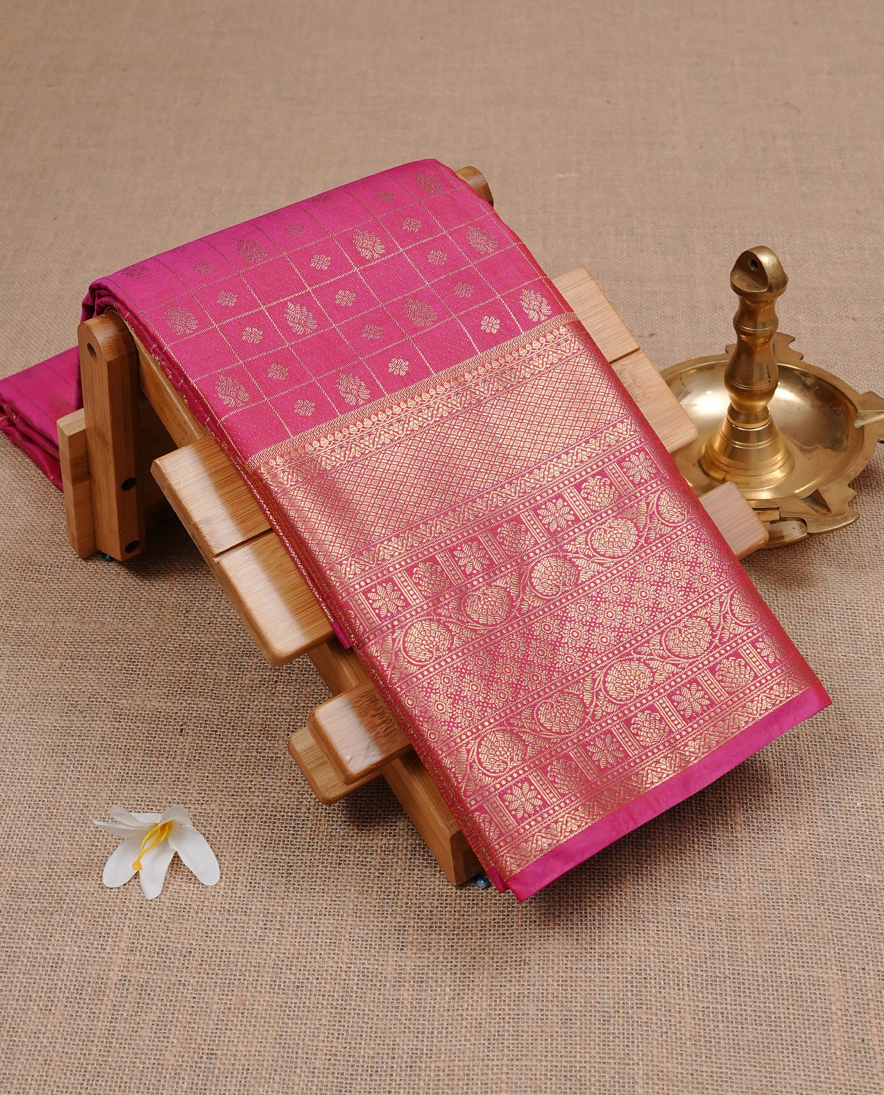 Magenta Semi Wedding Silk Saree featuring Gold Zari Check with Motifs On body, Complemented with traditional zari with Self colour border, paired with matching blouse piece.