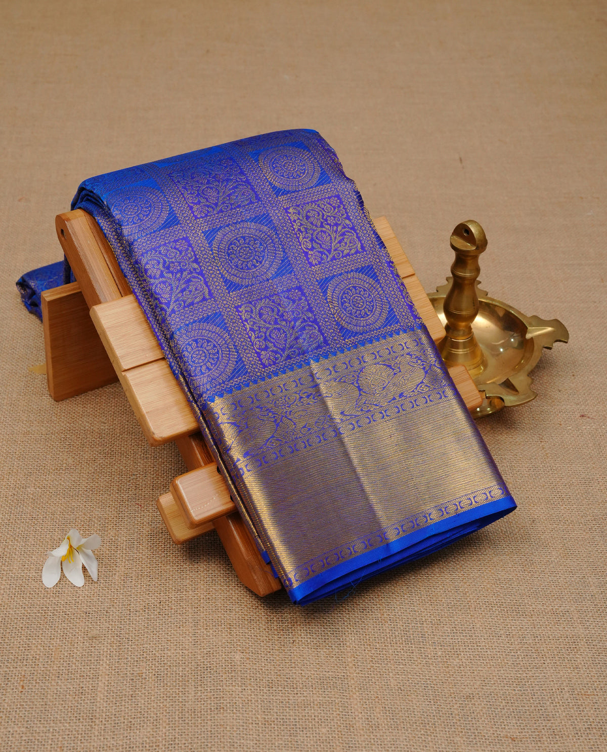 Blue colour Pure wedding silk saree featuring gold zari Check with designed & chakra motif pattern on body, complemented by self colour with traditional border, comes with a matching blouse piece.