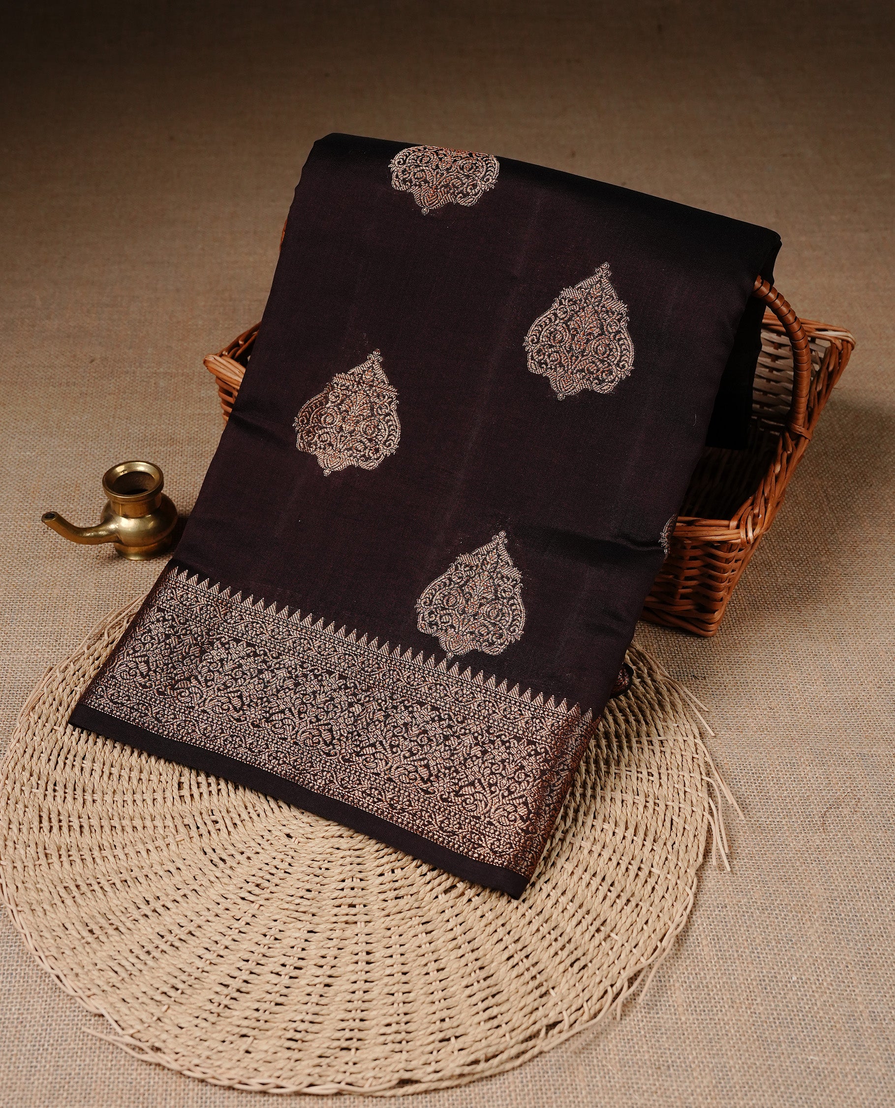 Chocolate Brown Colour Pure Banaras Soft Silk saree featuring Antique Zari buttas in body, complemented by zari work on self colour border, paired with matching Blouse Piece.