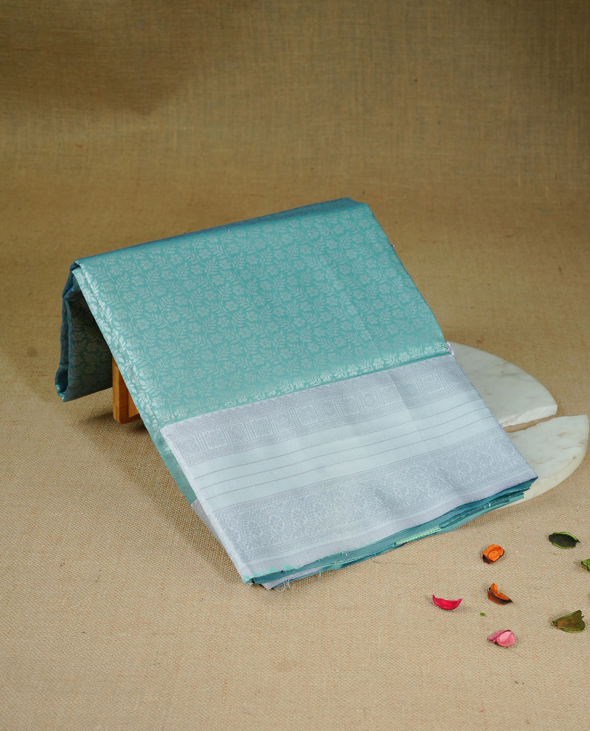 Sea green colour semi silk saree featuring Silver zari Floral pattern on body, complemented by contrast Lavender colour with silver zari border, comes with matching blouse piece.