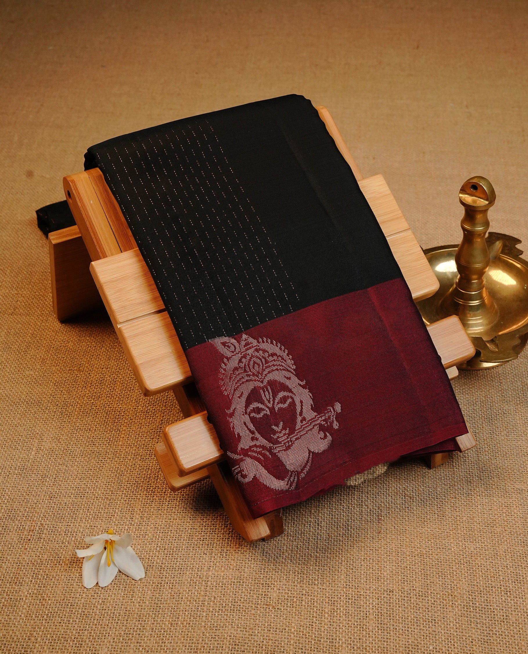 Black Colour Traditional Kancheepuram Silk Saree Featuring Gold Zari Stripes on the Body, Designed With Contrast Maroon & Gold Zari Lord Krishna Designed Pallu, Paired with a Matching Blouse.