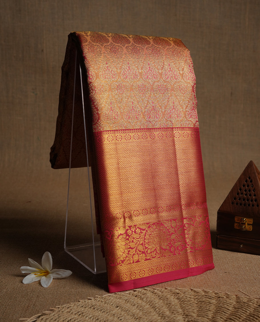 Reddish pink & gold double shade colour kancheepuram tissue silk saree highlighting gold zari pattern body, with contrast Reddish pink colour colour with traditional border and paired with matching blouse.