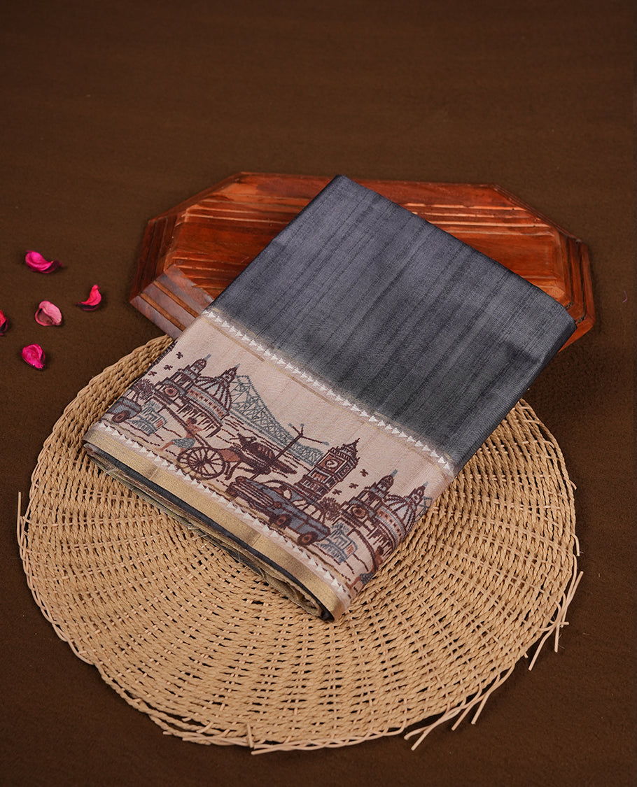 Gray colour semi tusser silk saree featuring contrast cream colour London bridge printed pattern border and paired with matching blouse.