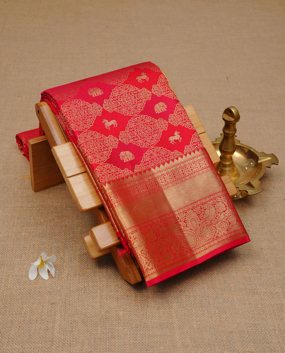 Red colour Pure Wedding silk saree featuring Animal buttas with Designed worked body, complemented by self colour with traditional border, comes with matching blouse piece.