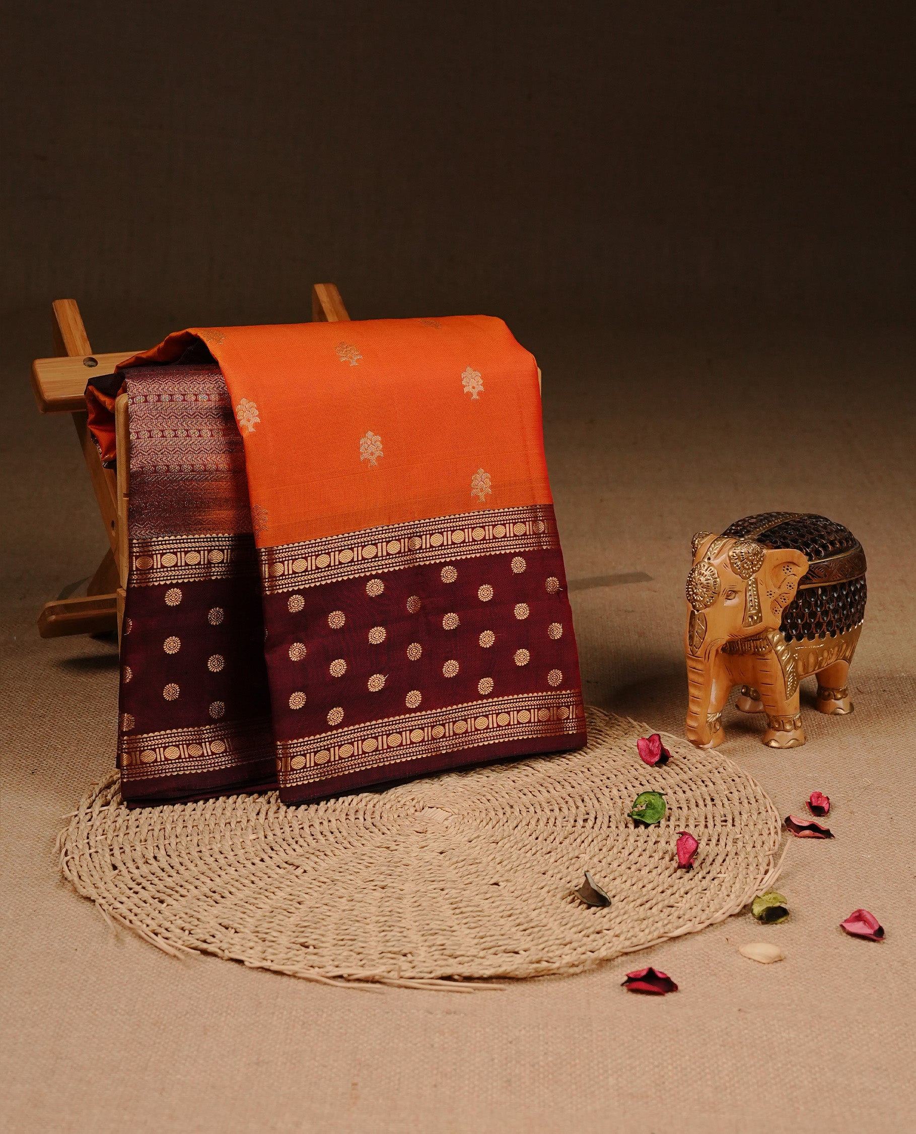 Orange colour Traditional Kancheepuram silk saree featuring gold zari motifs on body, enhanced with contrast Maroon with traditional border, paired with matching blouse piece.