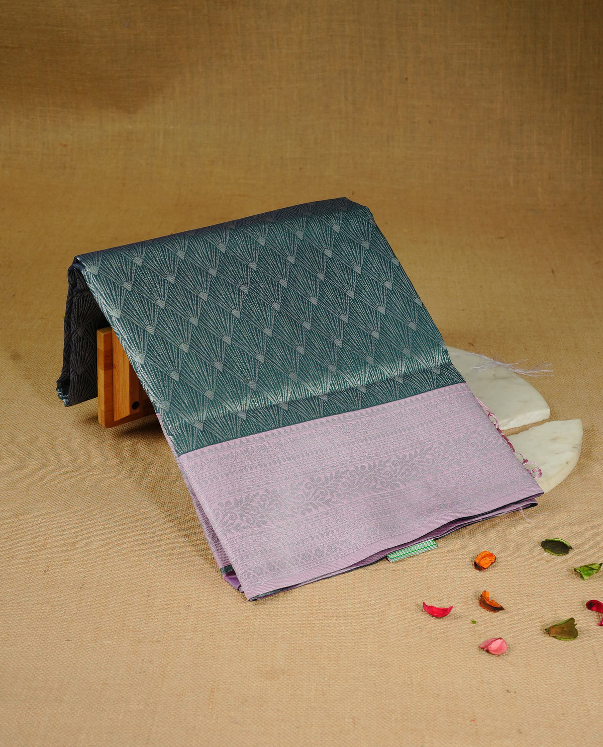 Green colour semi silk saree featuring Silver zari Design pattern on body, complemented by contrast Pink colour with silver zari border, comes with matching blouse piece