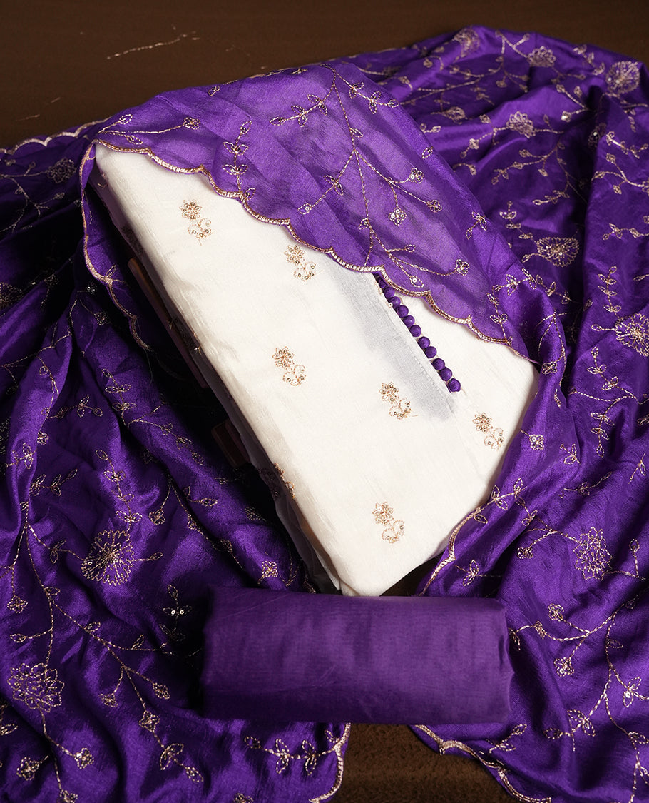 White colour churidhar material featuring thread embroidery on the front panel, contrast Violet colour dupatta with elegant border, and matching plain bottom