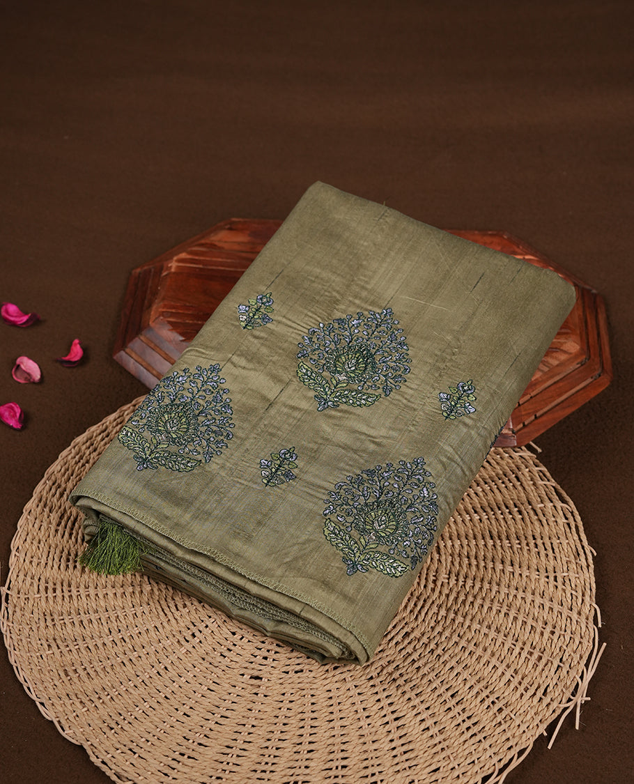 Green colour semi tusser silk saree featuring Floral thread embroidery across body, without border and paired with matching blouse.