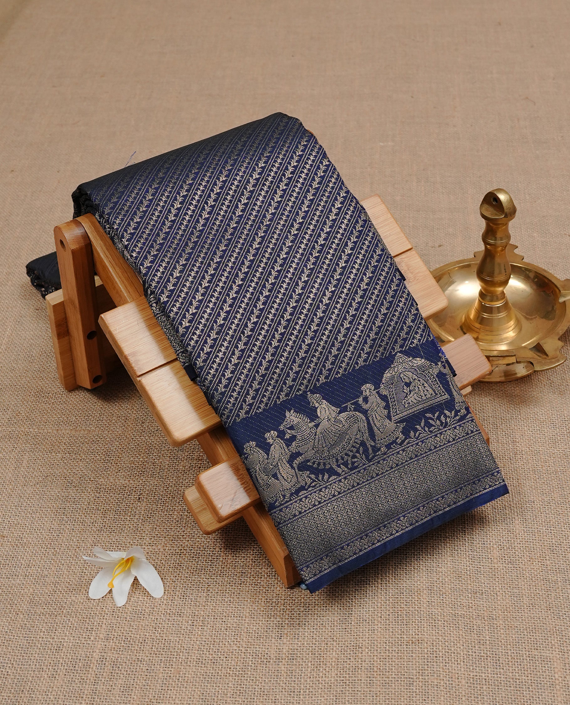 Dark Blue colour Semi wedding silk saree featuring Diagonal stripes on body, enchanced with self colour with gold zari pattern on border, paired with matching blouse piece.