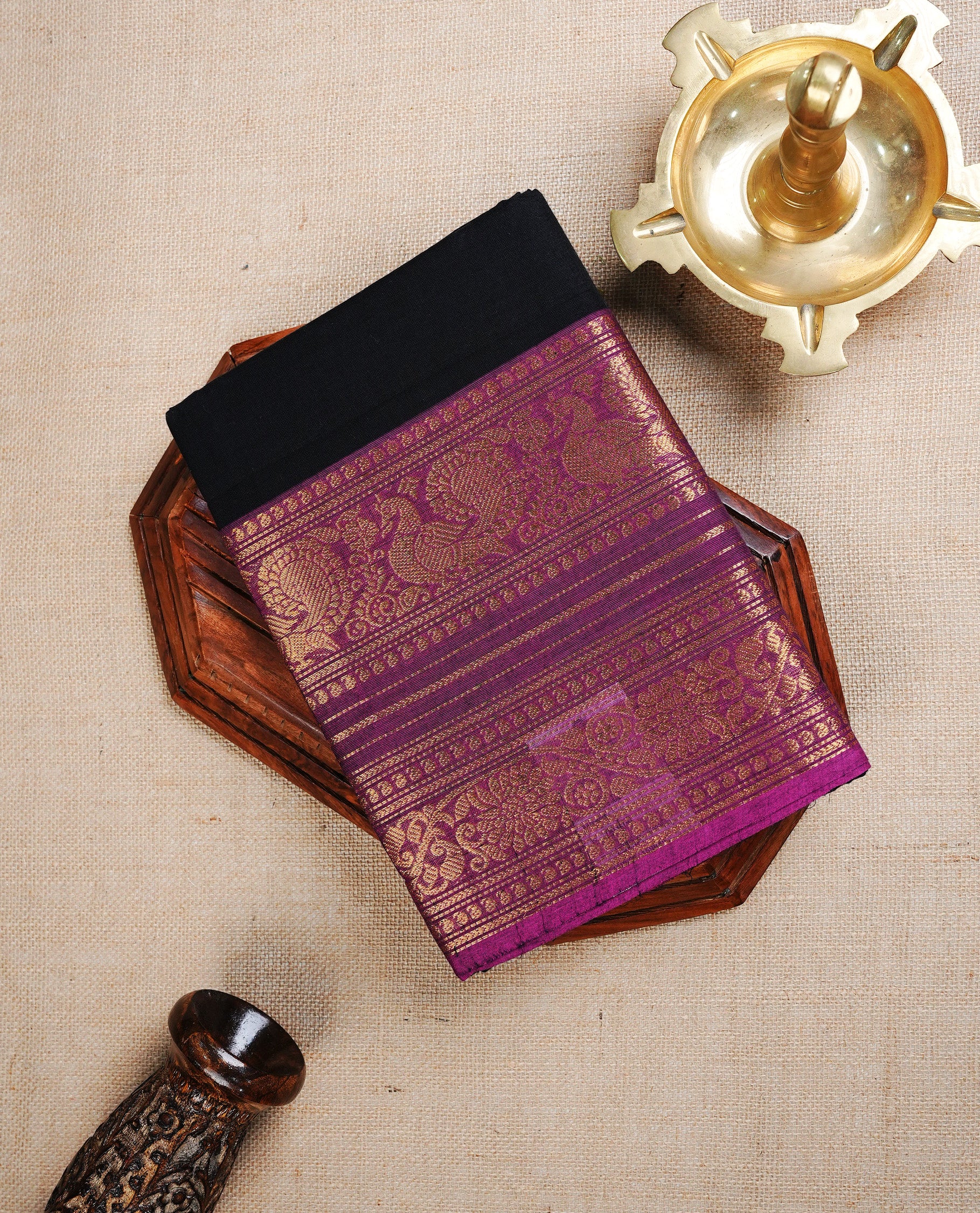 Black colour chettinad cotton saree featuring Plain body, complemented by Contrast Magenta Colour With Traditional Gold Zari border, paired with matching blouse piece.