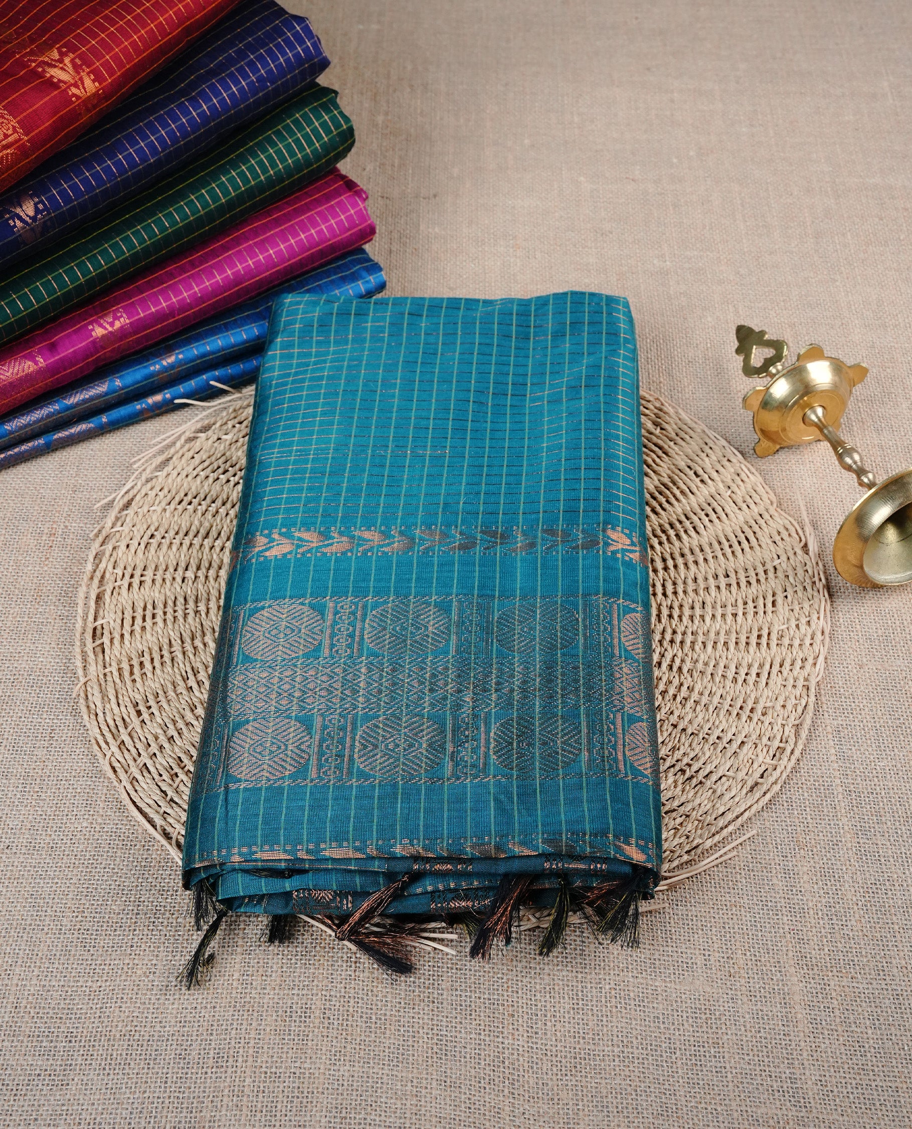 Peacock Blue colour Kalyani cotton saree featuring Gold zari checks on body, enhanced with zari border and grand zari pallu, comes with self colour blouse piece.
