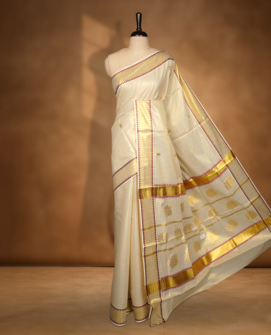 Elegant Light gold colour tissue Kerala saree with gold zari buttas, broad kasavu border with maroon temple design, and richly woven traditional pallu, paired with a matching blouse