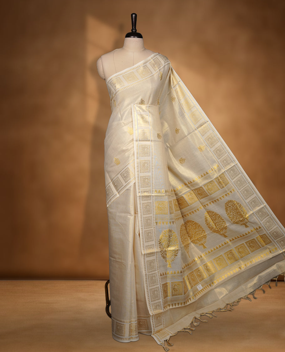 Elegant Light gold colour tissue Kerala saree with tree design gold zari buttas, broad kasavu border, and richly woven traditional pallu, paired with a matching blouse