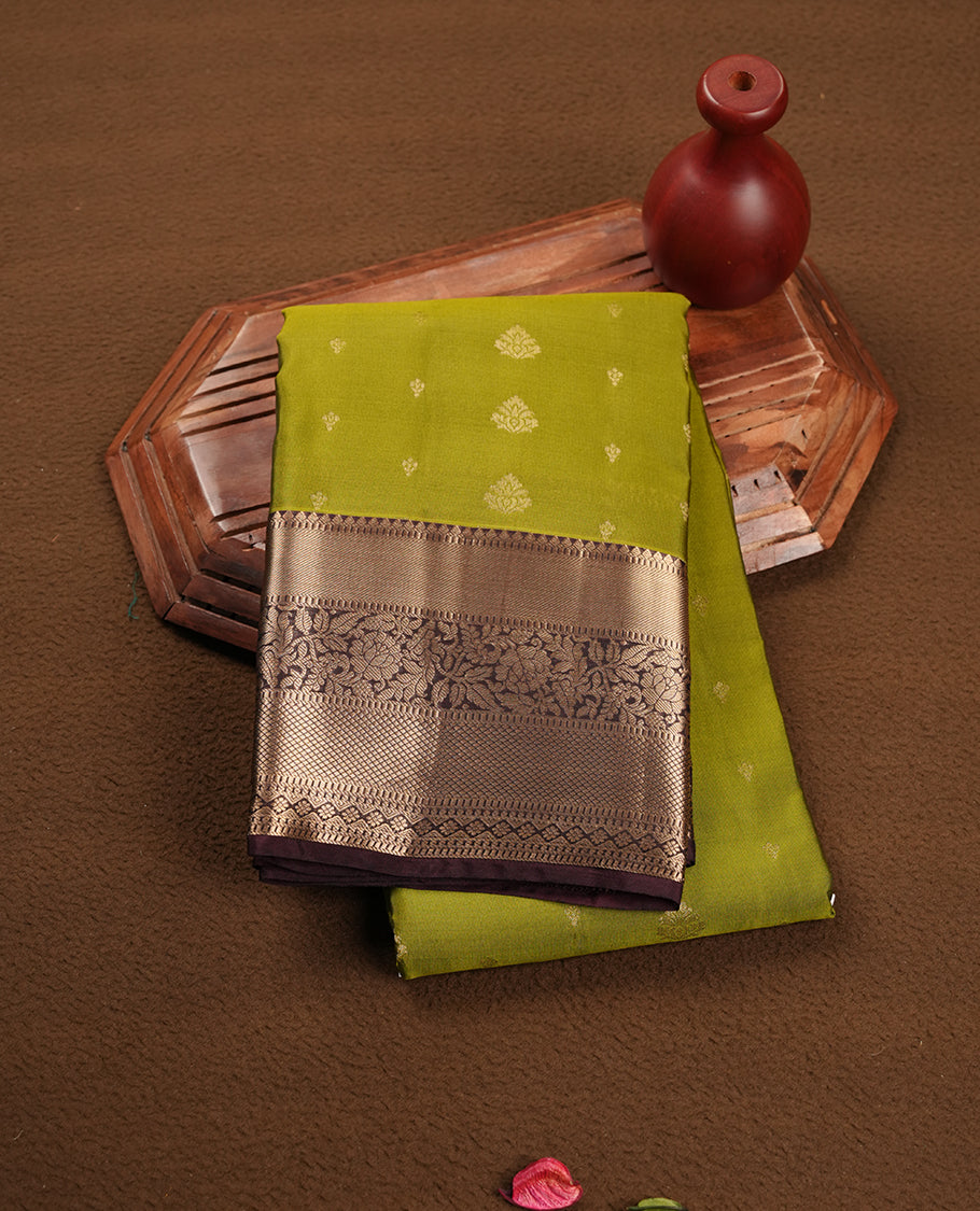 Lemon green colour soft silk saree featuring gold zari motifs on the body, complemented by a contrast chocolate traditional zari border and pallu, paired with matching blouse piece.