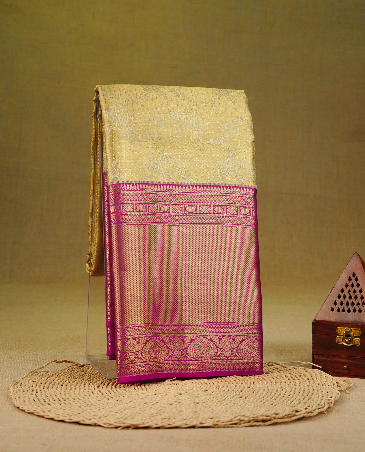Light Gold colour pure tissue silk saree featuring Gold zari Checks with Floral motifs on body, Complemented by magenta colour traditional border, comes with matching blouse piece.