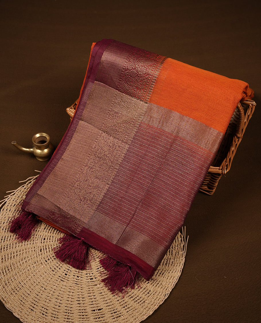 Burnt orange colour semi linen silk saree featuring antique zari motifs on body, traditional border with contrast maroon colour, pallu and paired with matching blouse