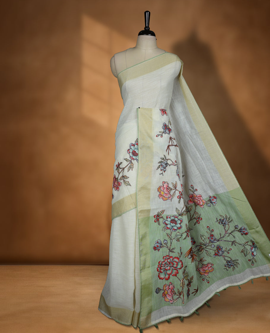 Cream colour cotton linen silk saree featuring Floral & brids printed pattern on body, golden simple border with green colour pallu and comes with a matching blouse