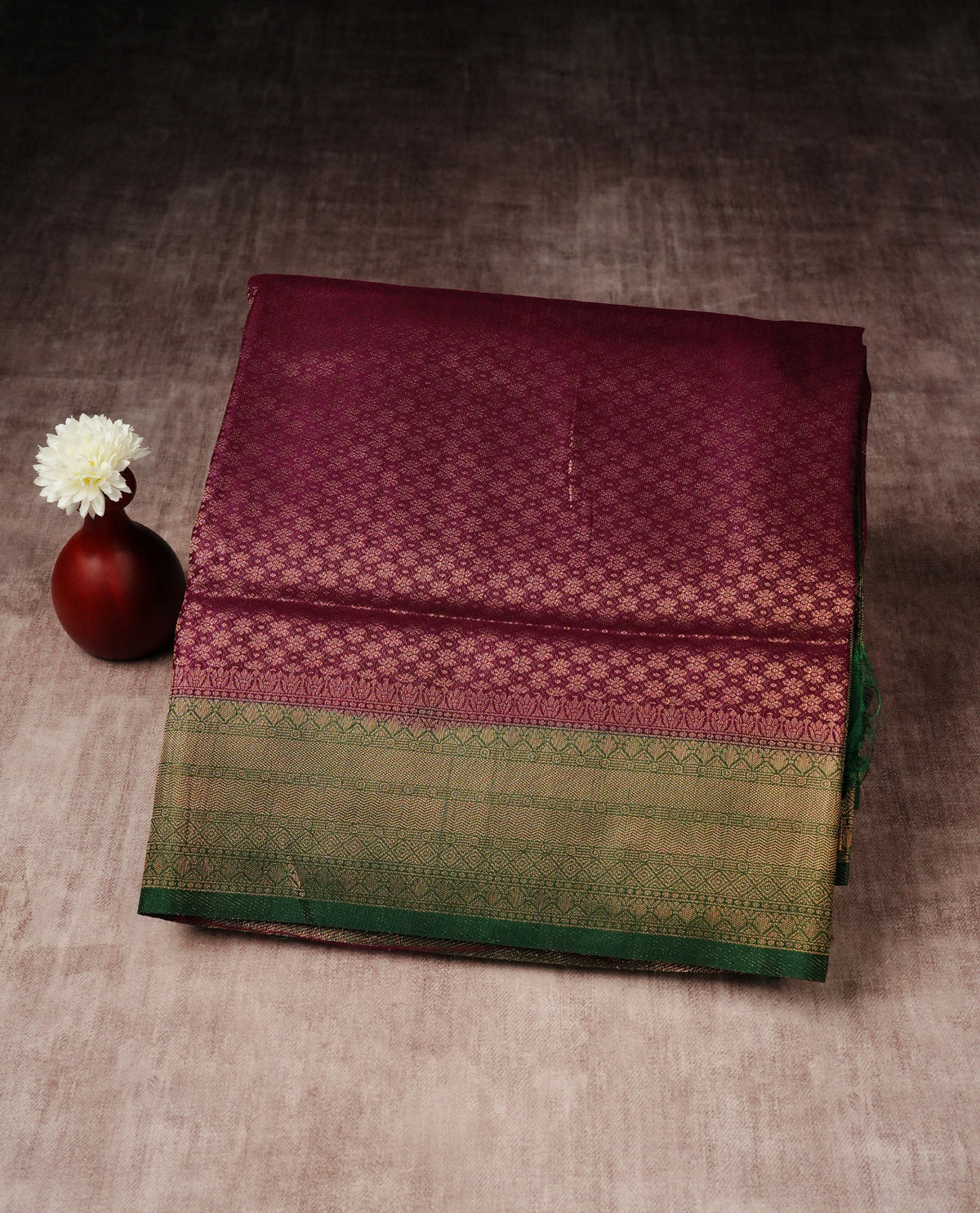 Maroon colour softie silk saree featuring gold zari, rich pallu floral pattern brocade body, with contrasting green colour border.paired with matching blouse piece.