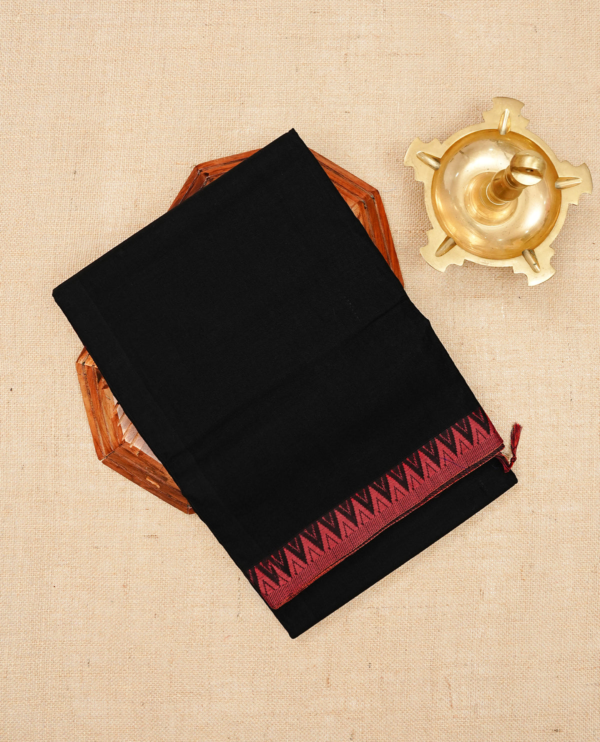 Black colour Narayanapattu cotton saree Featuing a plain body, complemented by a Red colour temple designed border & contrast pallu, paired with a matching blouse piece