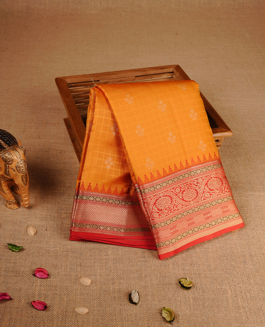 Mustard colour traditional kancheepuram silk saree featuring gold zari check pattern on body, complemented by contrast red colour with gold zari traditional border, paired with matching blouse piece.