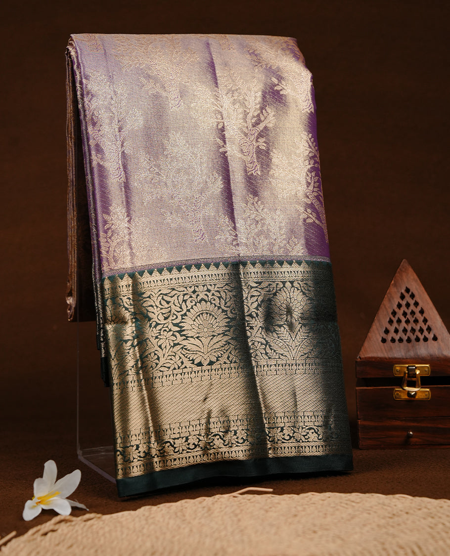 Purple & gold double shade colour semi tissue silk saree featuring gold zari tree pattern on body, contrast Green colour with gold zari traditional border, paired with matching blouse piece.