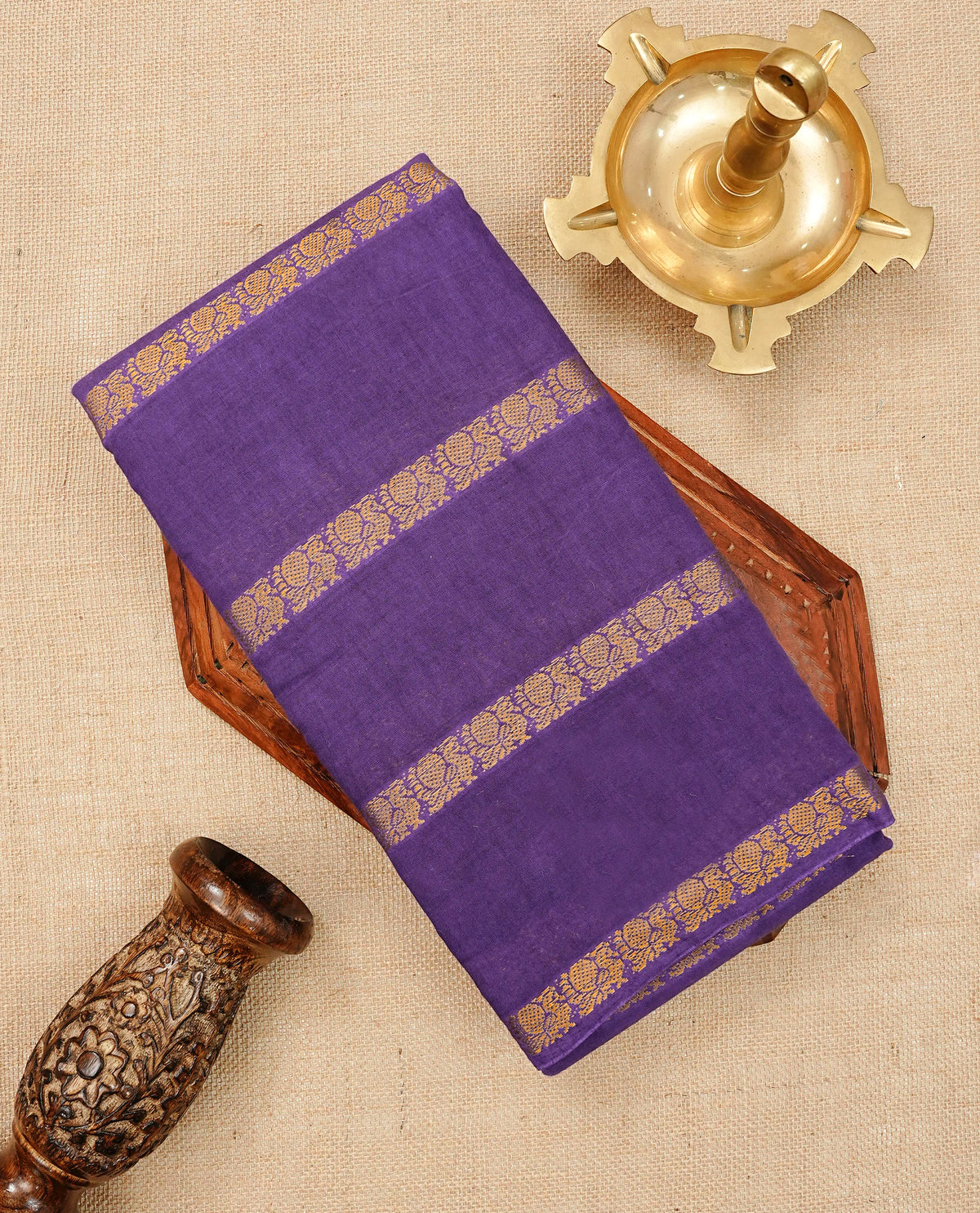 Purple Colour Sungudi Cotton Saree with peacock gold zari stripes on the body, a matching gold zari border, and a striped gold zari pallu. Paired with a contrast Magenta blouse piece featuring gold zari work.