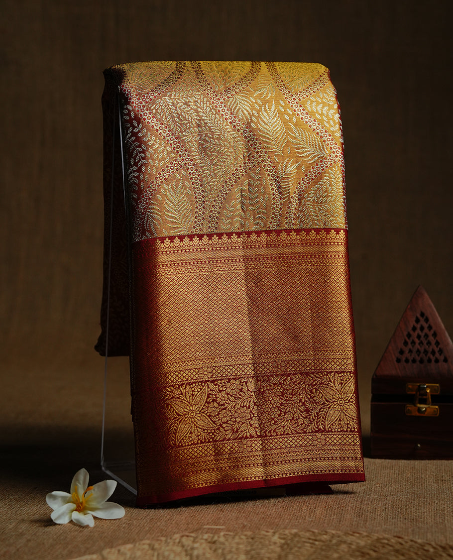 Gold & red double shade colour kancheepuram tissue silk saree featuring gold zari floral kodi pattern on body, complemented by contrast red colour with traditional border, paired with matching blouse piece.
