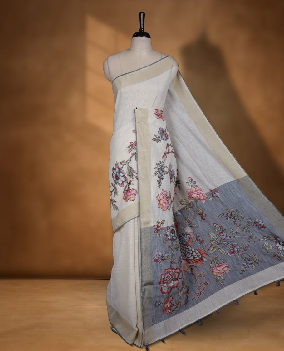 Cream colour cotton linen silk saree featuring Floral & brids printed pattern on body, golden simple border with gray colour pallu and comes with a matching blouse