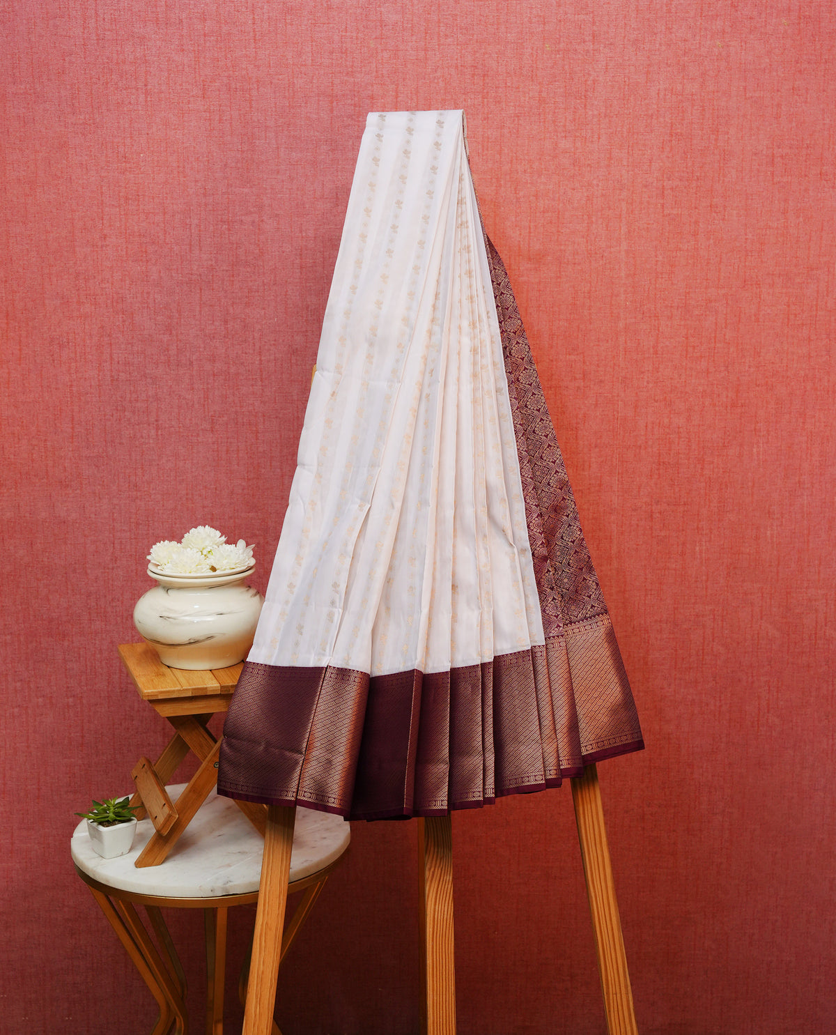 Off white colour silk saree featuring gold zari buttas on body, contrast maroon with gold zari traditional border, contrast grand pallu comes with matching blouse piece .