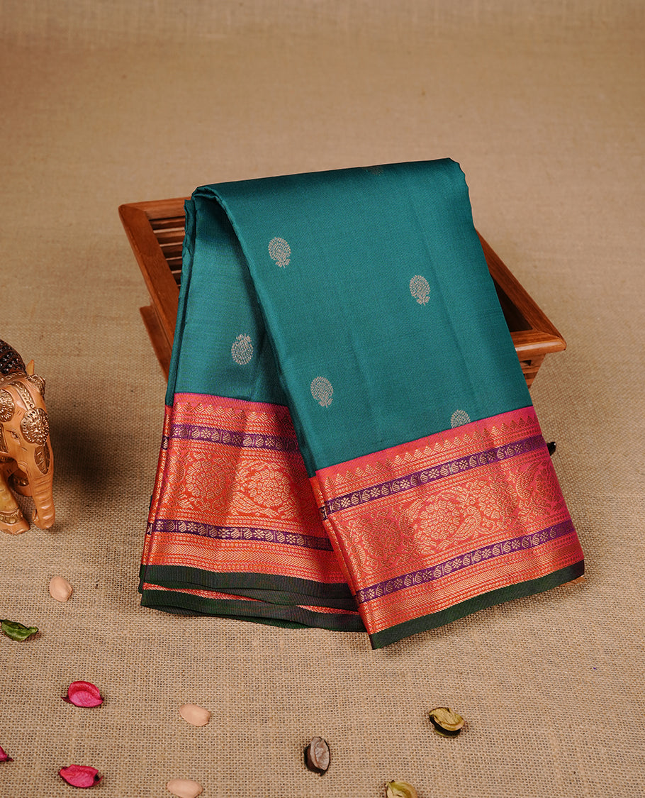 Peacock green colour traditional kancheepuram silk saree featuring gold zari motifs on body, complemented by contrast orange & purple colour with gold zari traditional border, paired with matching blouse piece.