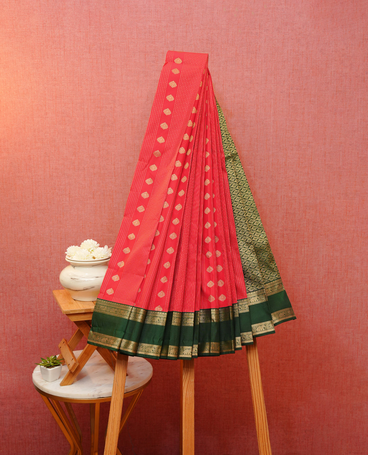 Red colour soft silk saree featuring gold zari stripes with floral motifs on body, contrast dark green colour gold zari elephant & peacock traditional border, grand pallu comes with matching blouse piece.