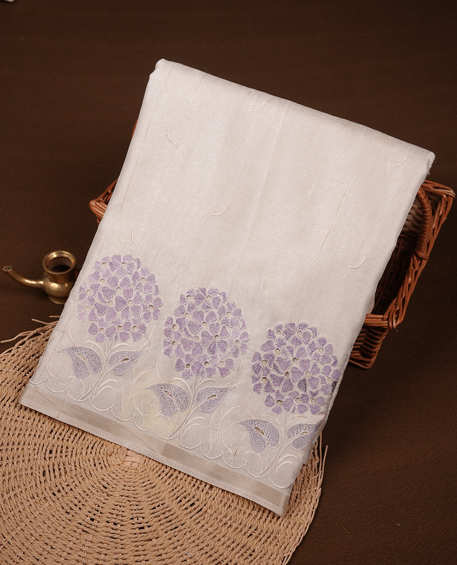 Beige colour Tussar silk saree featuring Elegant plain body, highlighting Lavender colour floral cut work with Light gold zari border, pallu and paired with matching blouse piece.