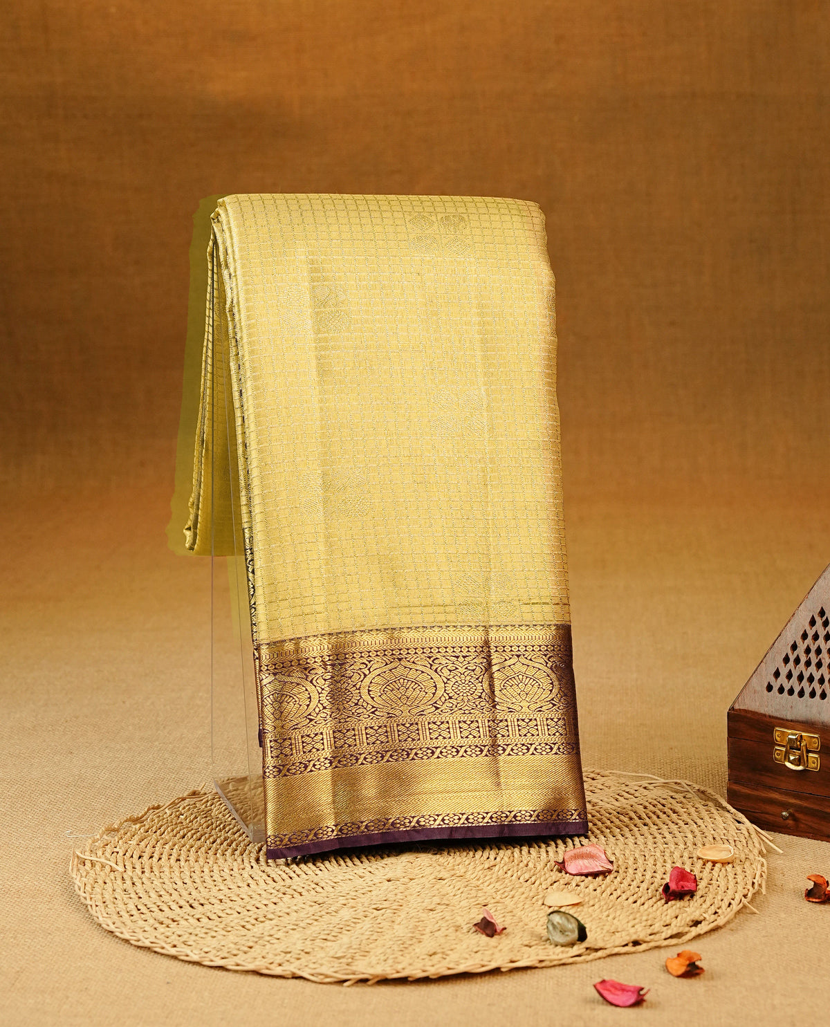 Gold colour Semi Tissue Silk Saree featuring gold zari checks with peacock motifs on the body, complemented by an intricately woven gold zari pallu, a rich Purple border with gold zari work and paired with a matching plain blouse piece.