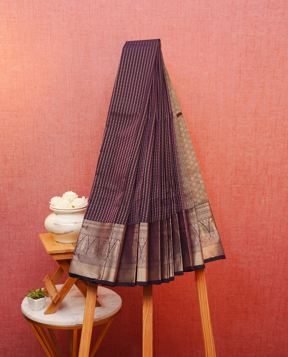 Dark purple colour soft silk saree featuring gold zari buttas on body, contrast self colour gold zari traditional border, grand pallu comes with matching blouse piece.